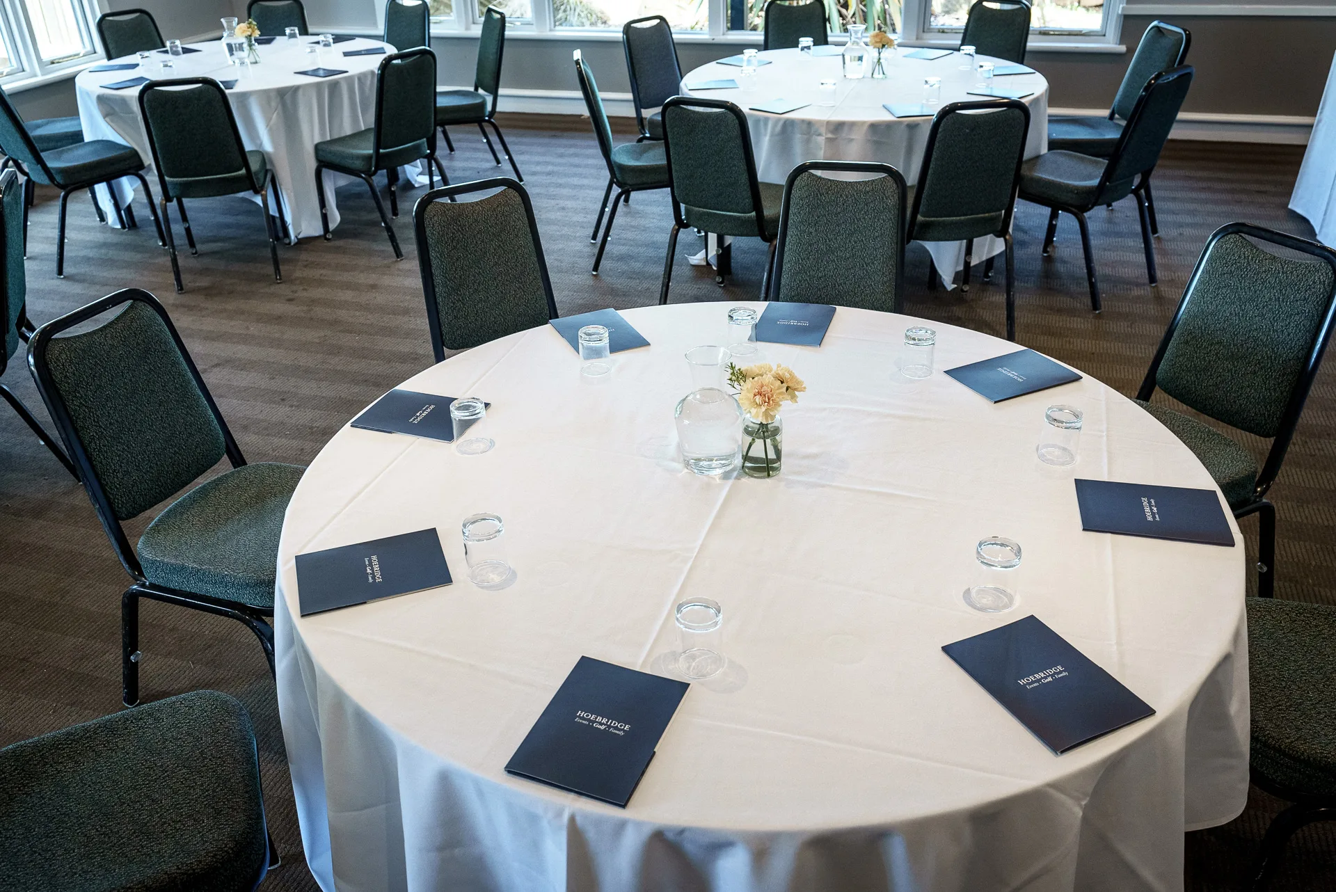 meeting room arranged with personalised notepads at a conference venue in woking