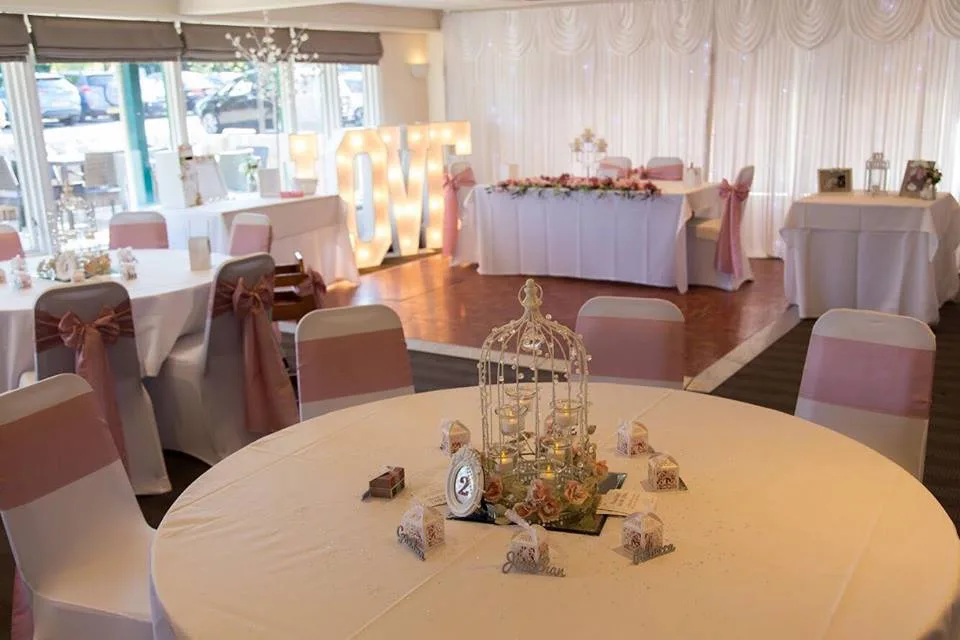 beautiful wedding reception decorated with pink accents at a wedding venue in woking