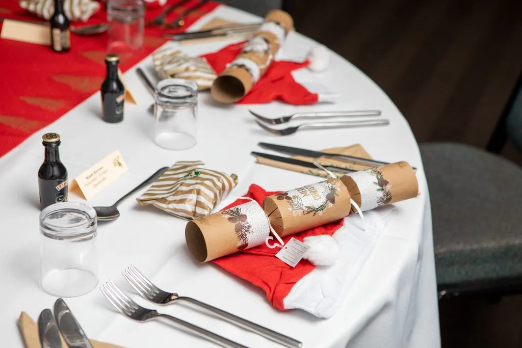 christmas crackers decorated on tables at a christmas party in woking