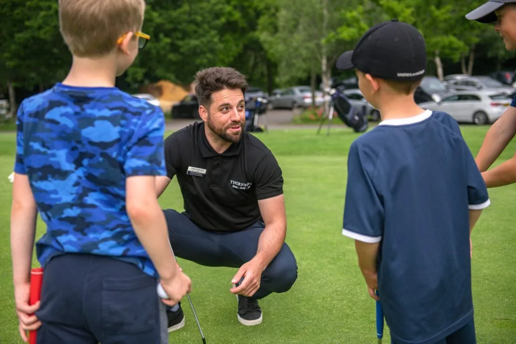 golf coach helping juniors get into golf at a group golf lesson in surrey