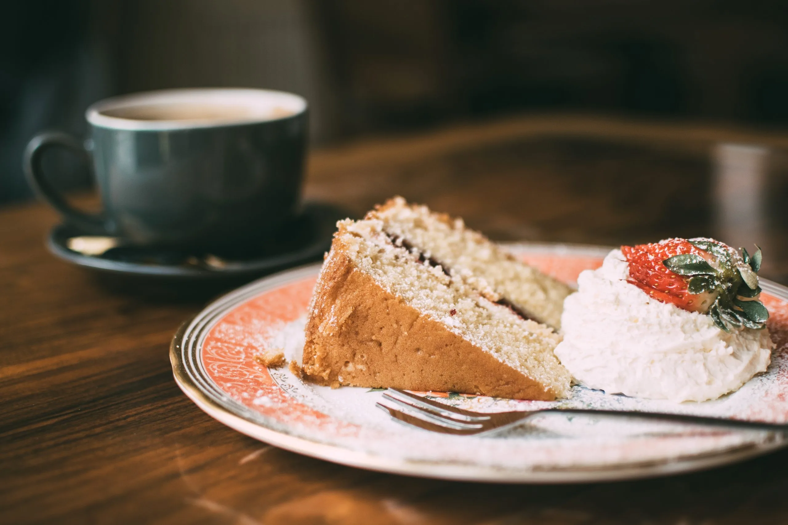 fluffy cake with cream and a coffee at an afternoon tea in woking