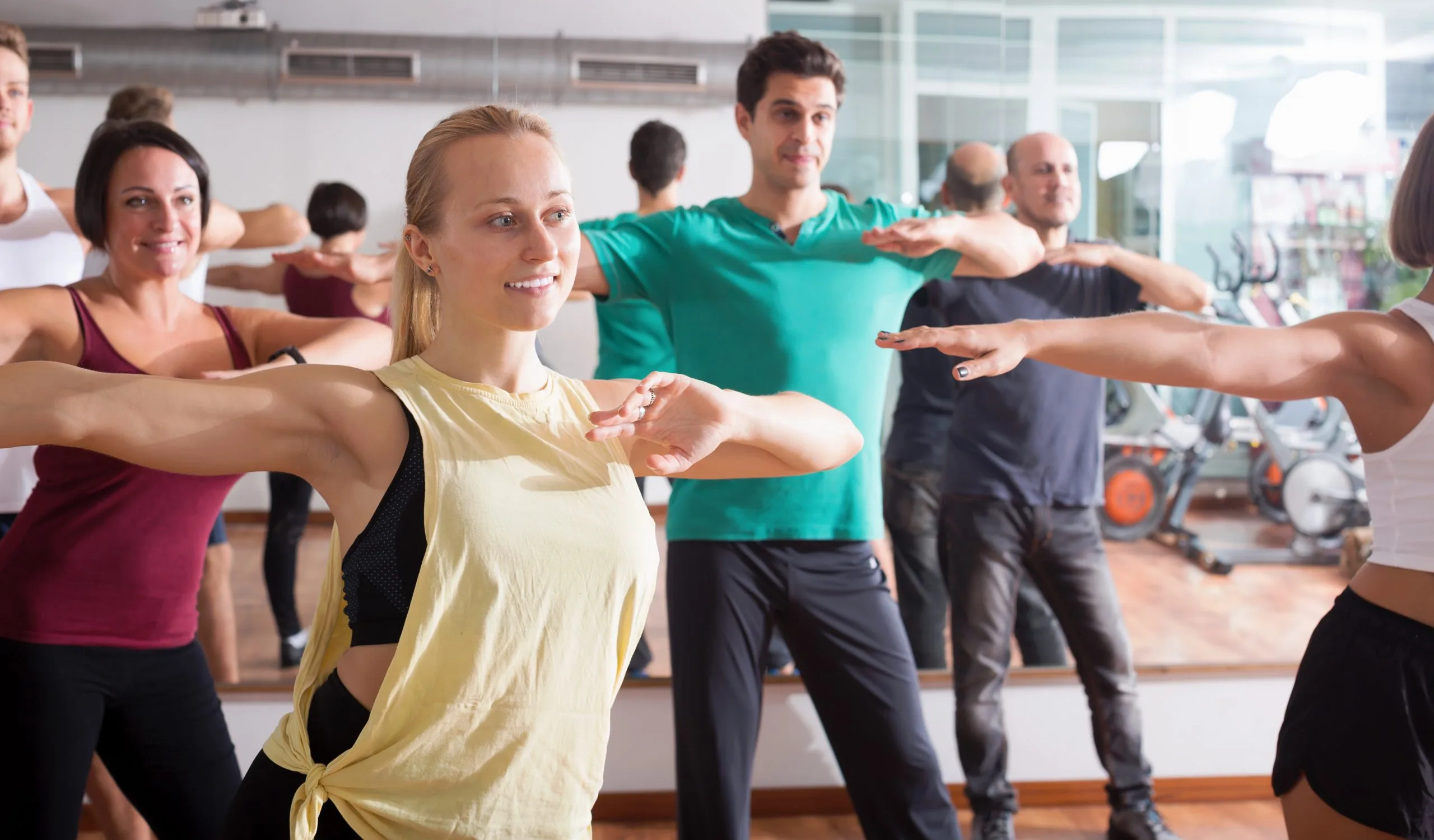 group fitness class with participants smiling at a group fitness class in woking