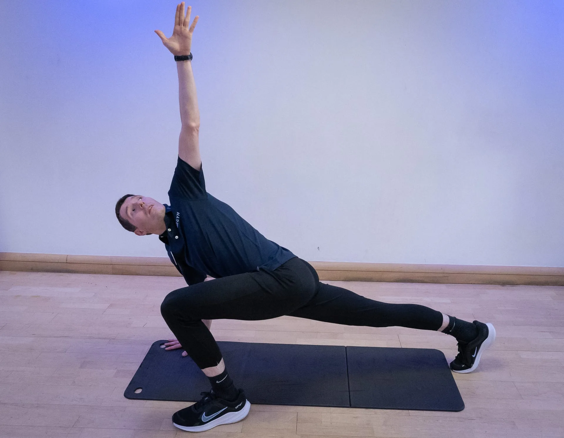 man stretching on mat at gym near guildford