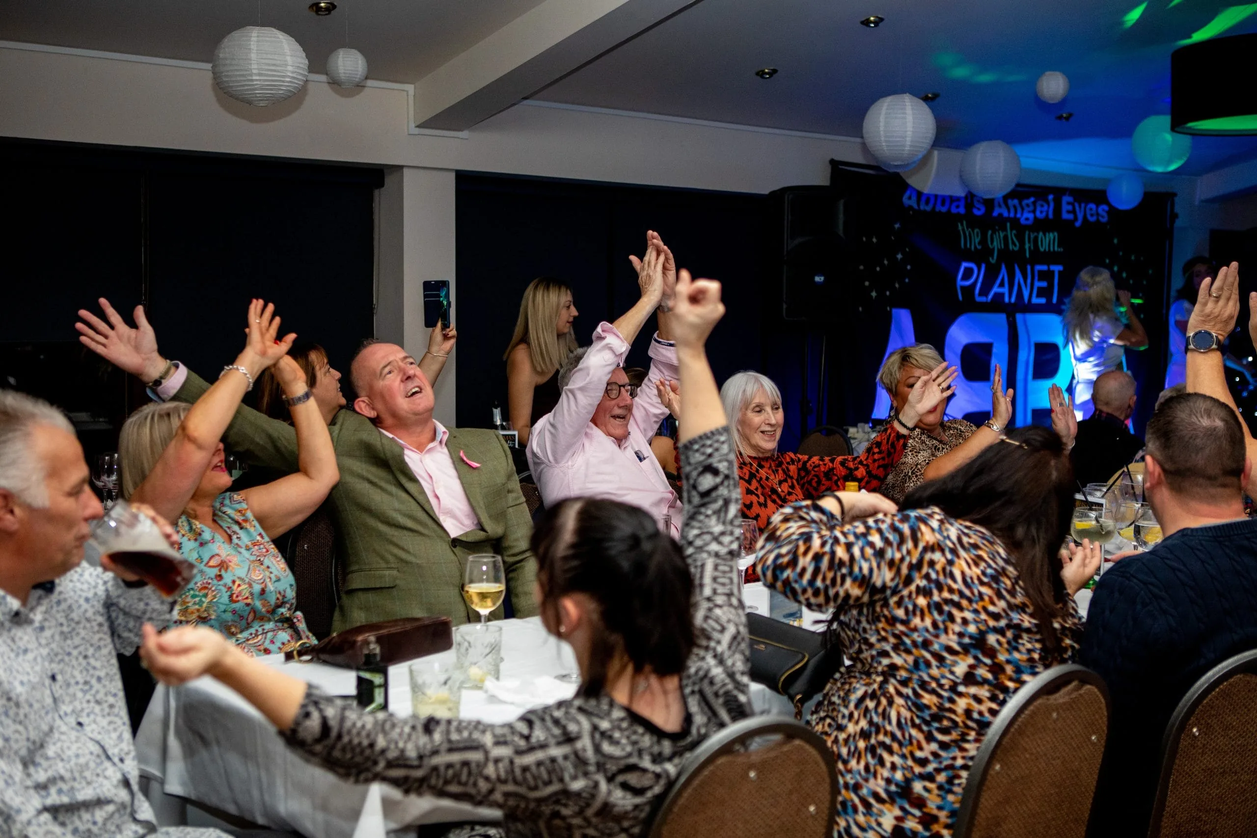 Guests dancing and singing at ABBA tribute night at events venue Woking